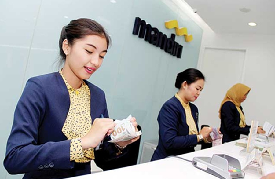 <p>Ilustrasi pegawai bank Mandiri. Simak tabel angsuran KUR Mandiri Oktober 2025, lengkap syarat dan cara pengajuan modal pembiayaan usaha bagi UMKM.</p>
